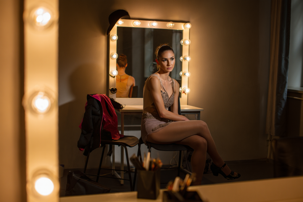 Женщина в зеркале перед выступлением &mdash; самовыражение через танец и давление чужих взглядов